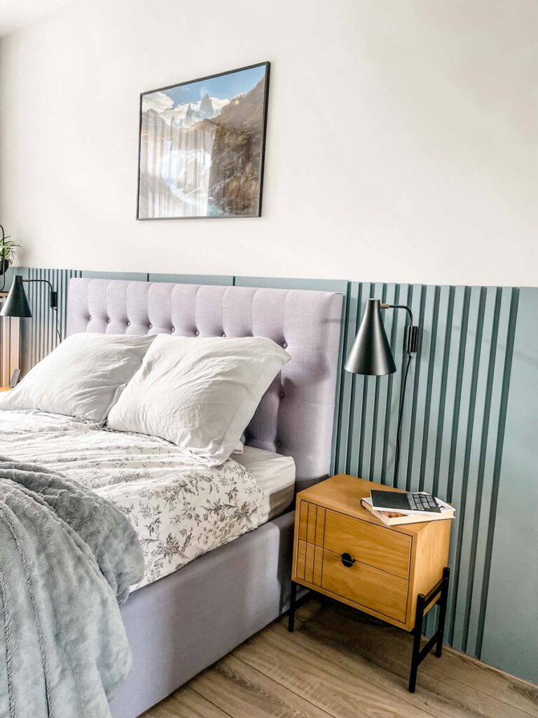 wooden bedside tables with black wall lamp