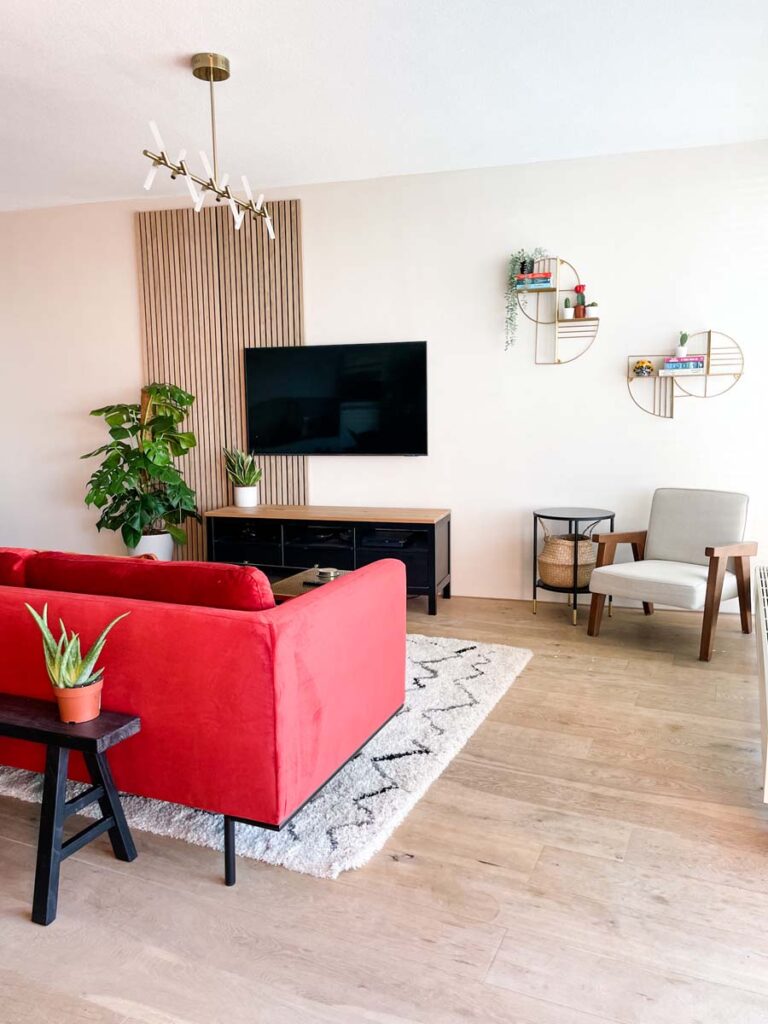 Living room with reading corner and red velvet sofa