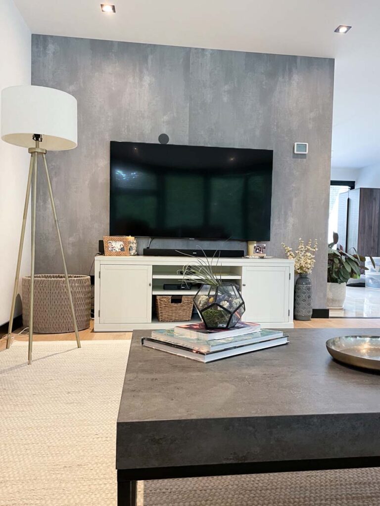 wall mounted tv above white console table