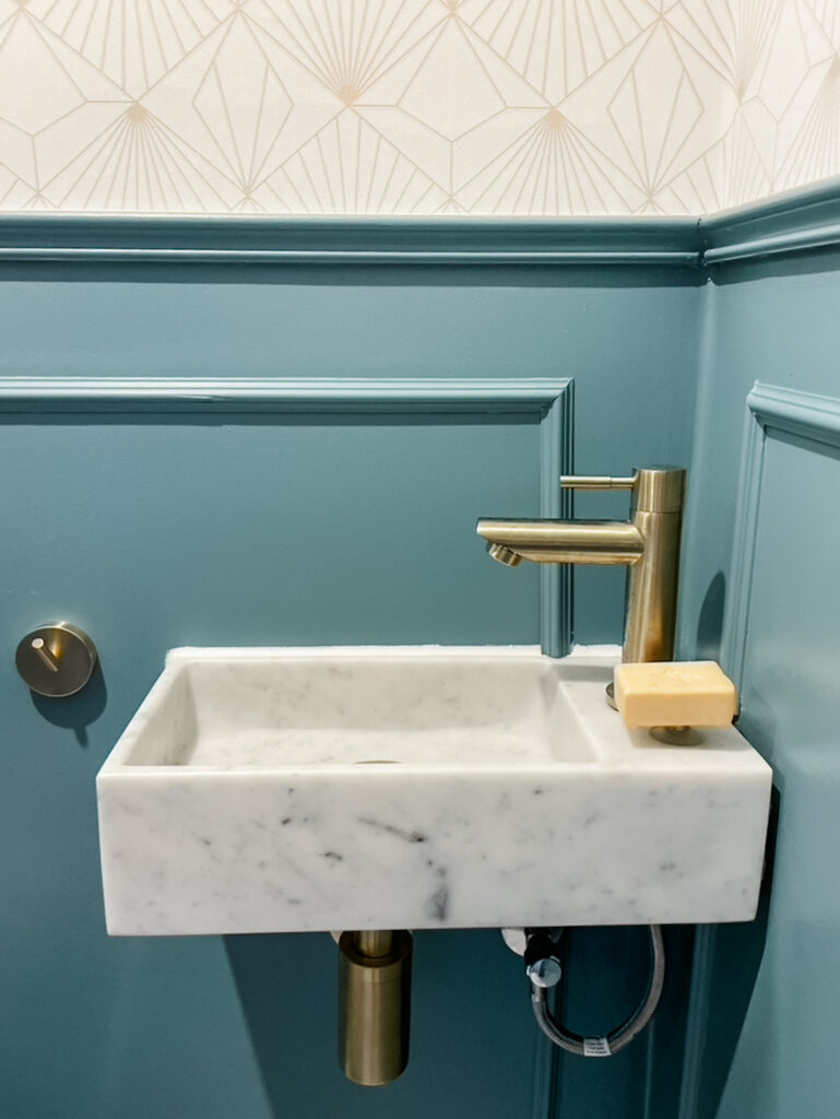 marble bathroom sink with gold taps