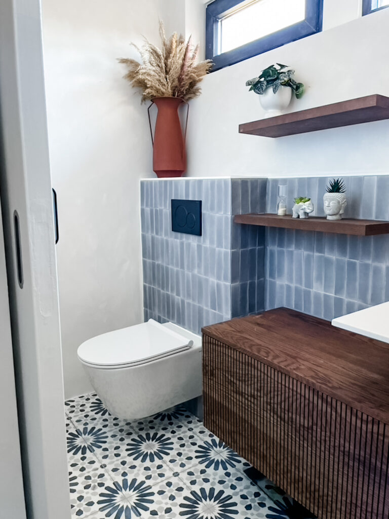 ribbed walnut bathroom vanity and floating shelves
