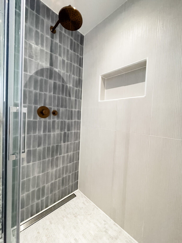 two tone bathroom tiles with rainshower